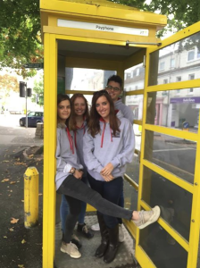 law students in phone box