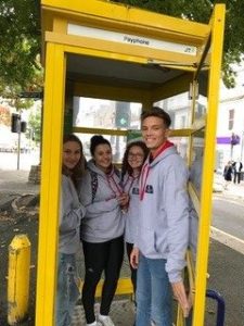 Institute of Law students squeezing in a telephone box