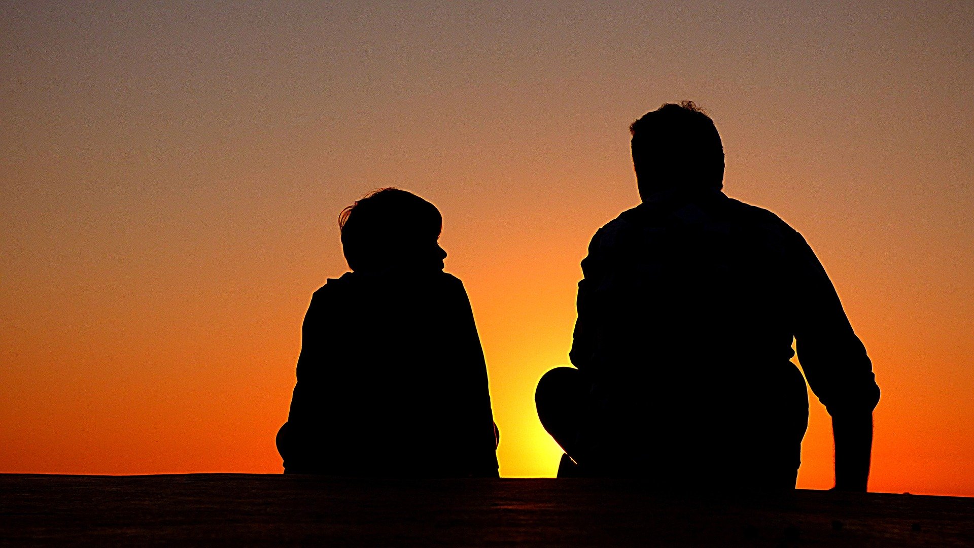 sunset silhouettes man and child